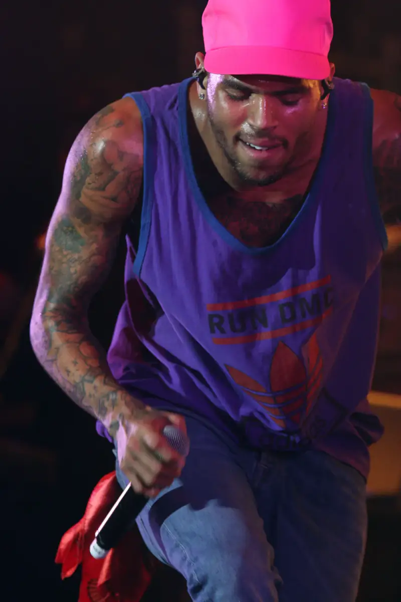 Chris Brown performing live in a pink cap and Run DMC tank top, April 2012