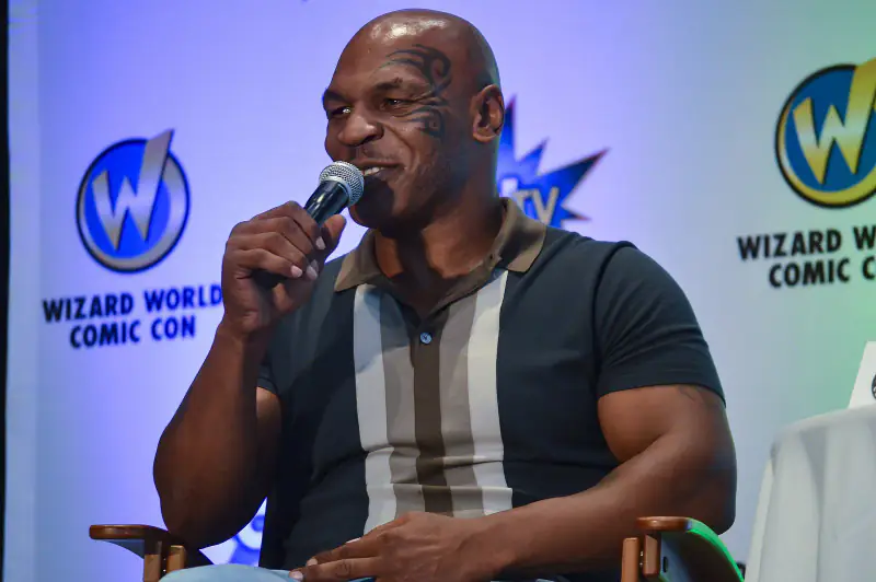 Mike Tyson speaking into a microphone on a panel at Wizard World Comic Con, 2015